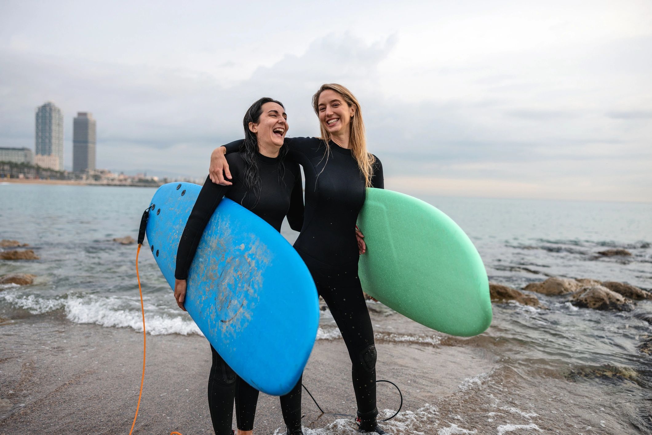 Smiling surfers walking from the water with boards