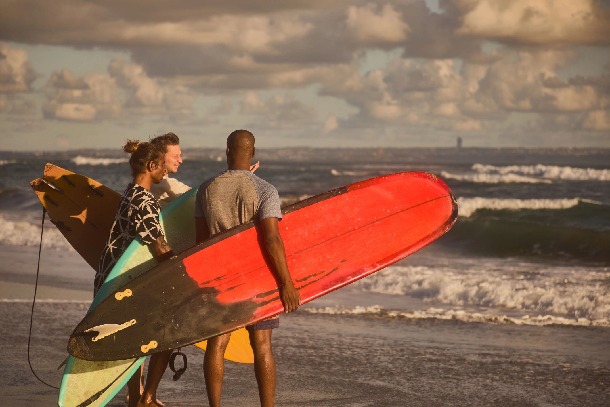 Group of friends with surfboards at the beach