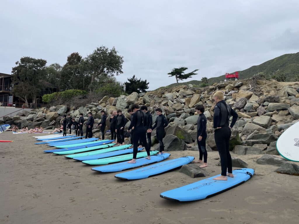 Beginner Surfers on their boards during a surf lesson in Ventura